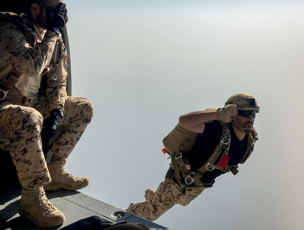 Bahrain Defense Forces paratrooper salutes as he jumps