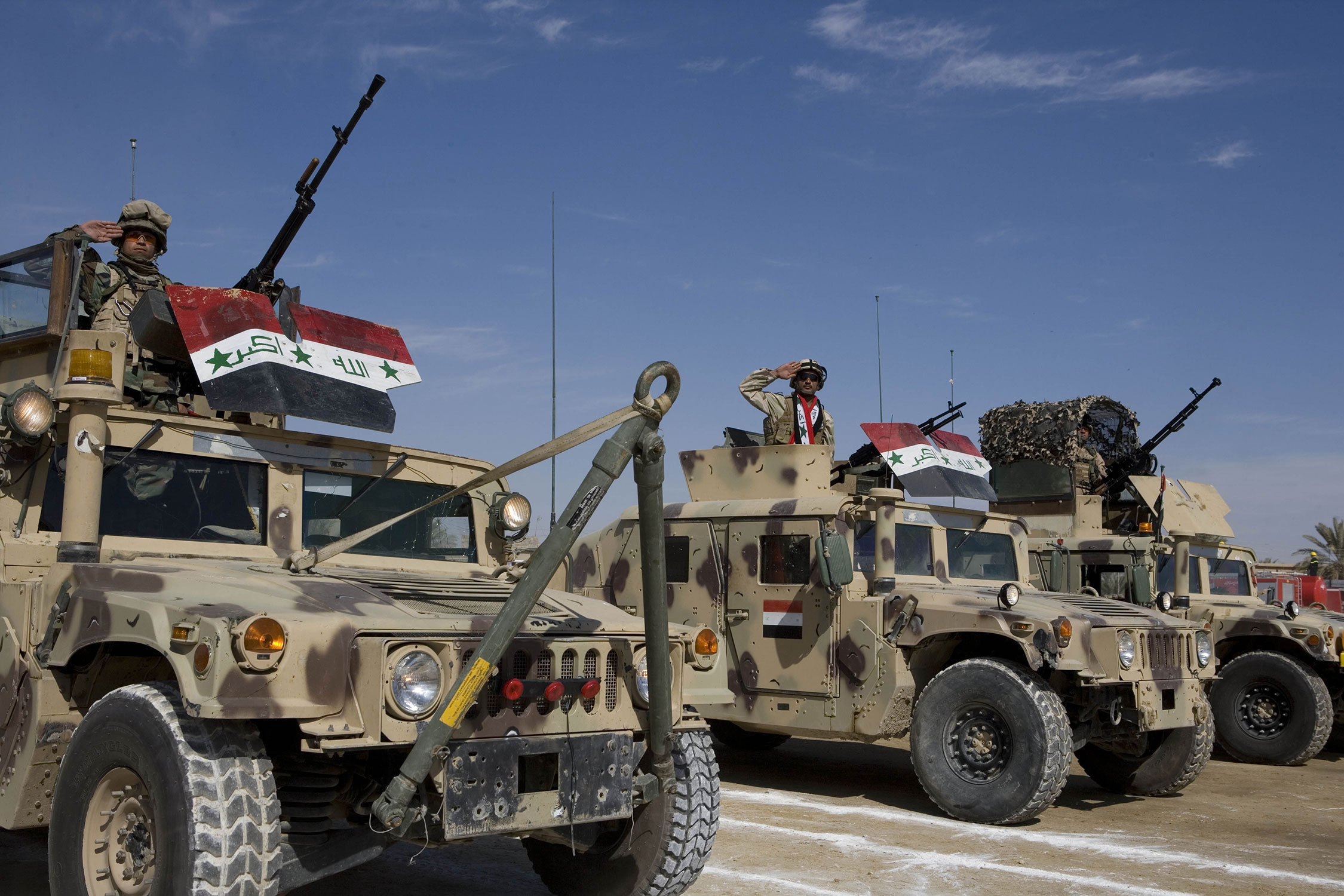 Iraqi Security Forces salute from Humvees