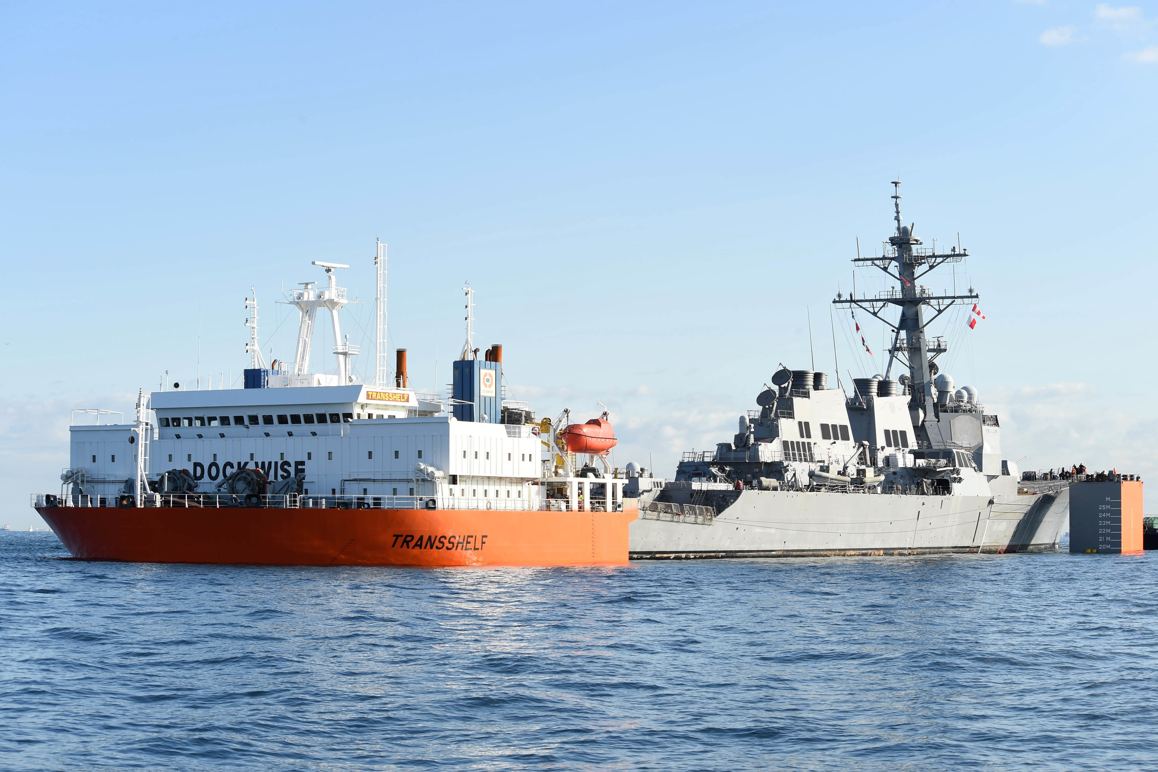 USS Fitzgerald is loaded on a transport ship for final repairs
