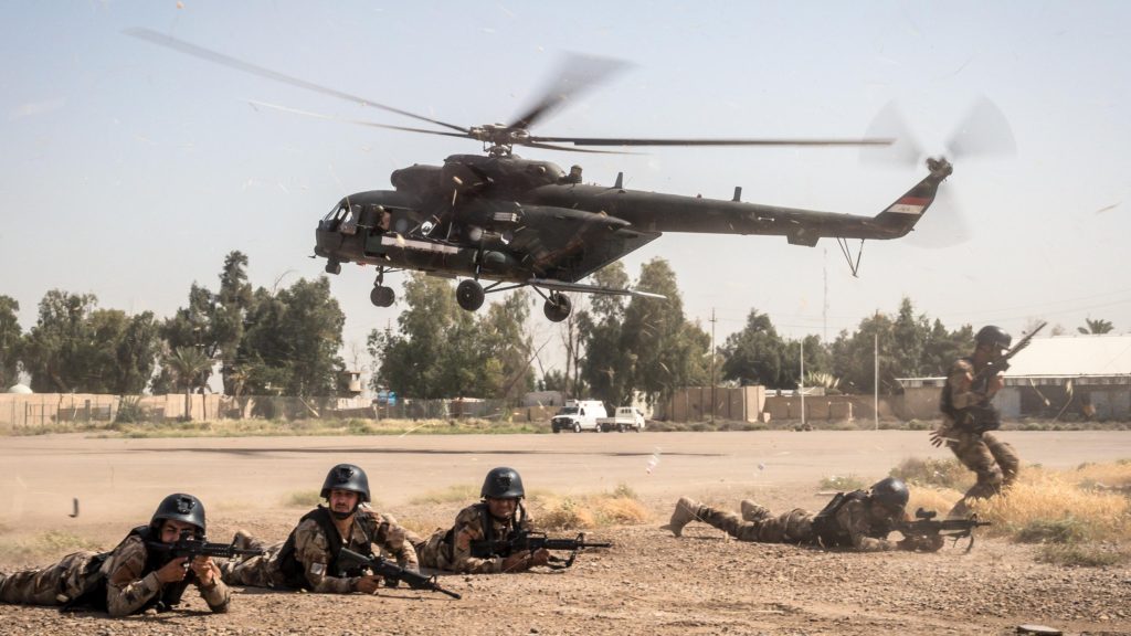 Iraqi special operations forces provide security for a helicopter