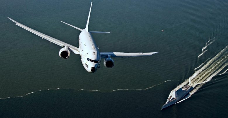 P-8A Poseidon flies over USS Zumwalt