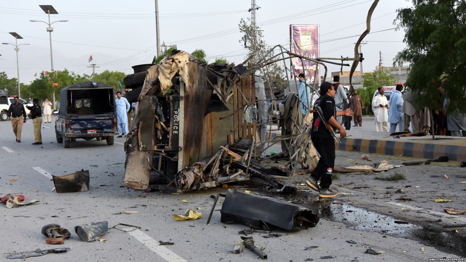 Pakistani security officials inspect a police truck after a bomb blast in in Quetta on April 24, 2018