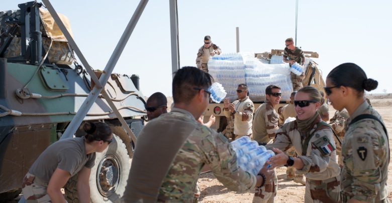 French and American forces offload supplies in Syria's Euphrates River Valley in May 2018