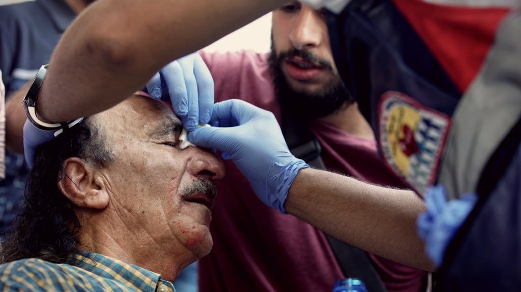 An old man is wounded after stun grenades and rubber bullets are fired into a crowd of Palestinians in East Jerusalem, Israel/Palestine