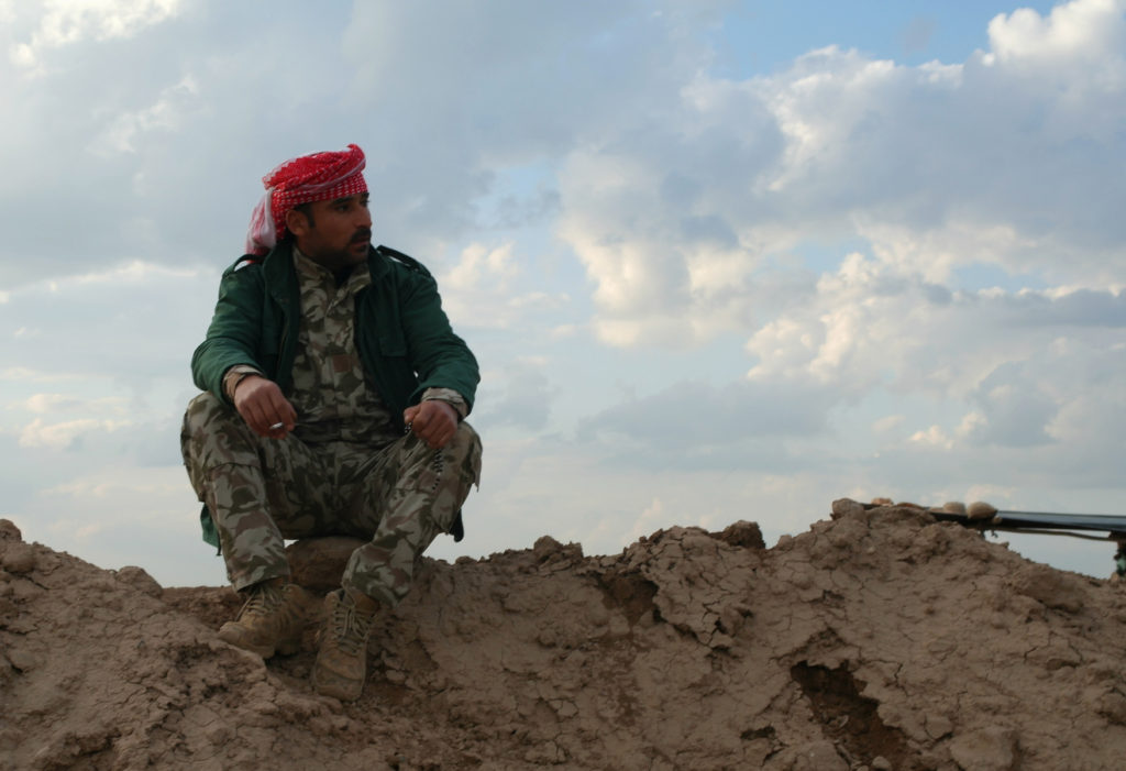 Peshmerga takes a cigarette break on the Gwer frontline in Iraq