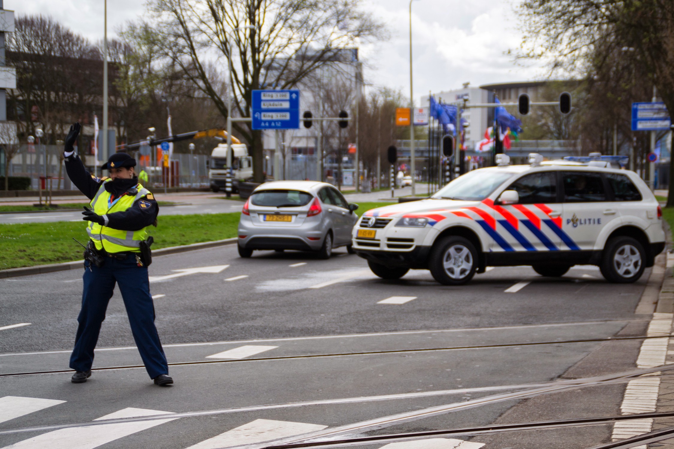 Dutch police officer regulates traffic at 2014 Nuclear Security Summit in the Netherlands