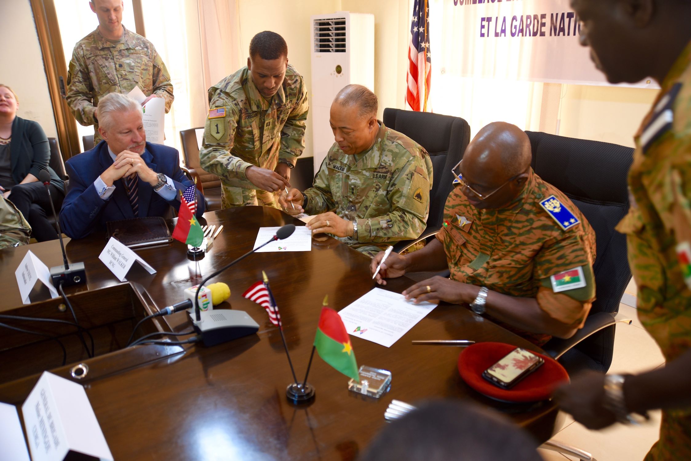 Maj. Gen. William J. Walker, Commanding General, District of Columbia National Guard and Brig. Gen. Moses Miningou the Chief of General Staff for the National Armed Forces of Burkina Faso, participate in a formal signing ceremony