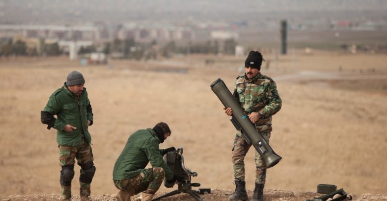 Peshmerga soldiers disassemble a Milan anti- tank missile system