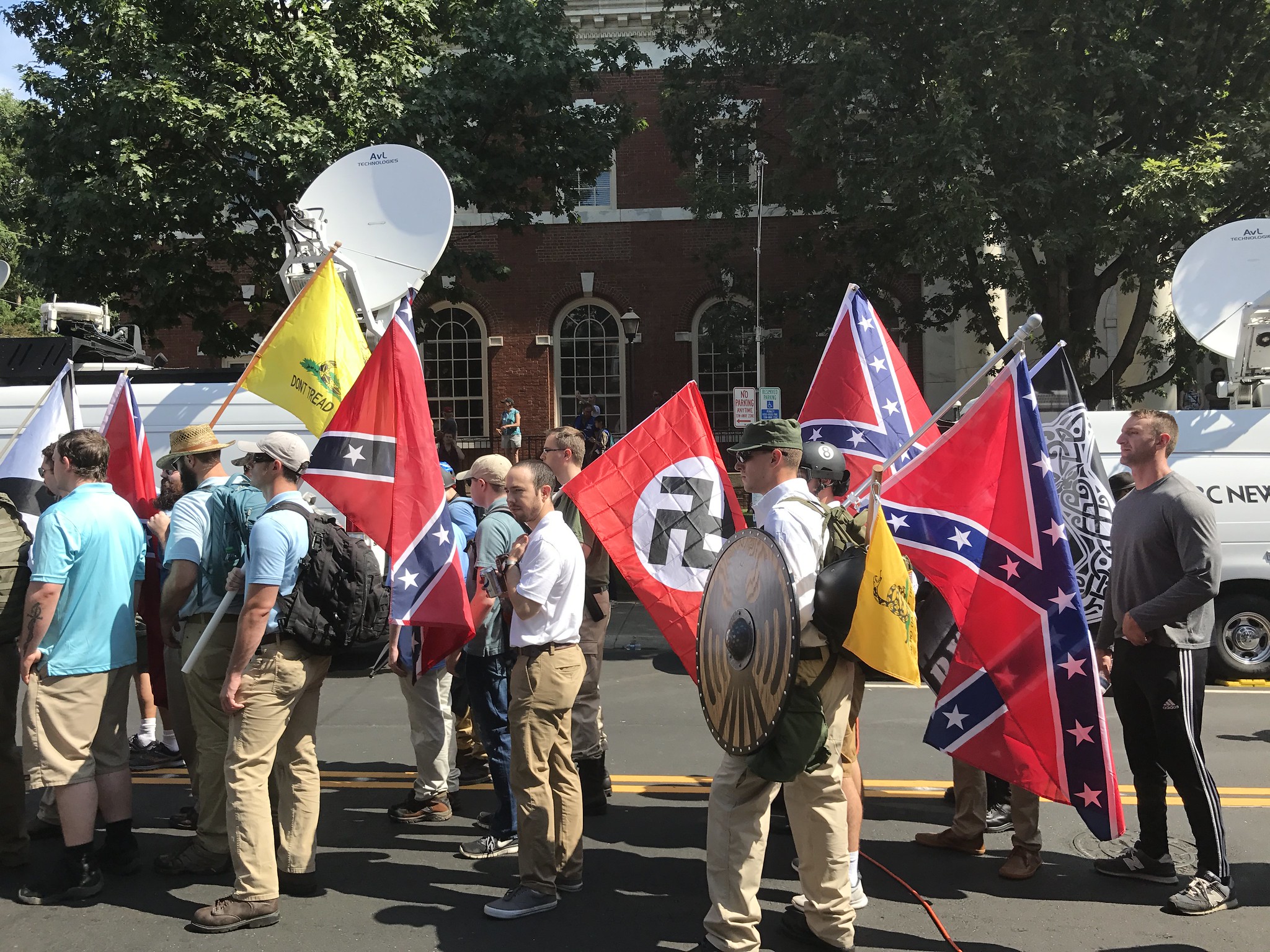 Alt-right members preparing to enter Emancipation Park holding Nazi, Confederate Battle, Gadsden 
