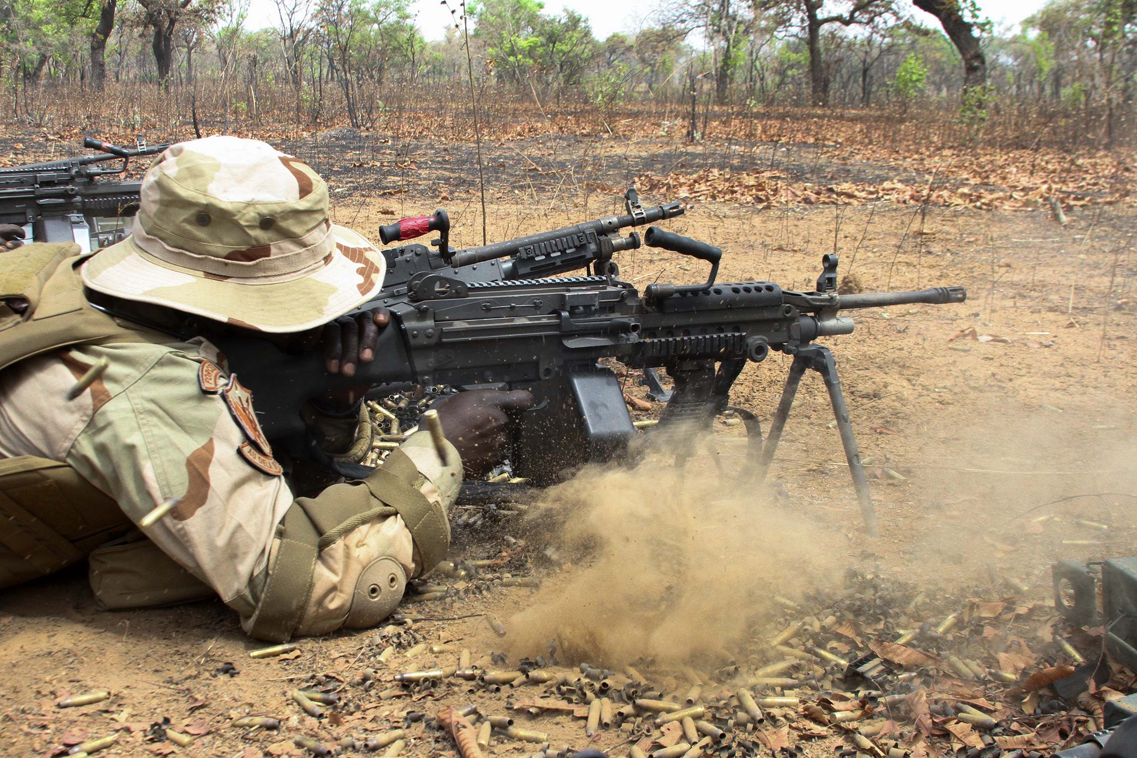 Senegal special forces soldier fires an M249 machine gun