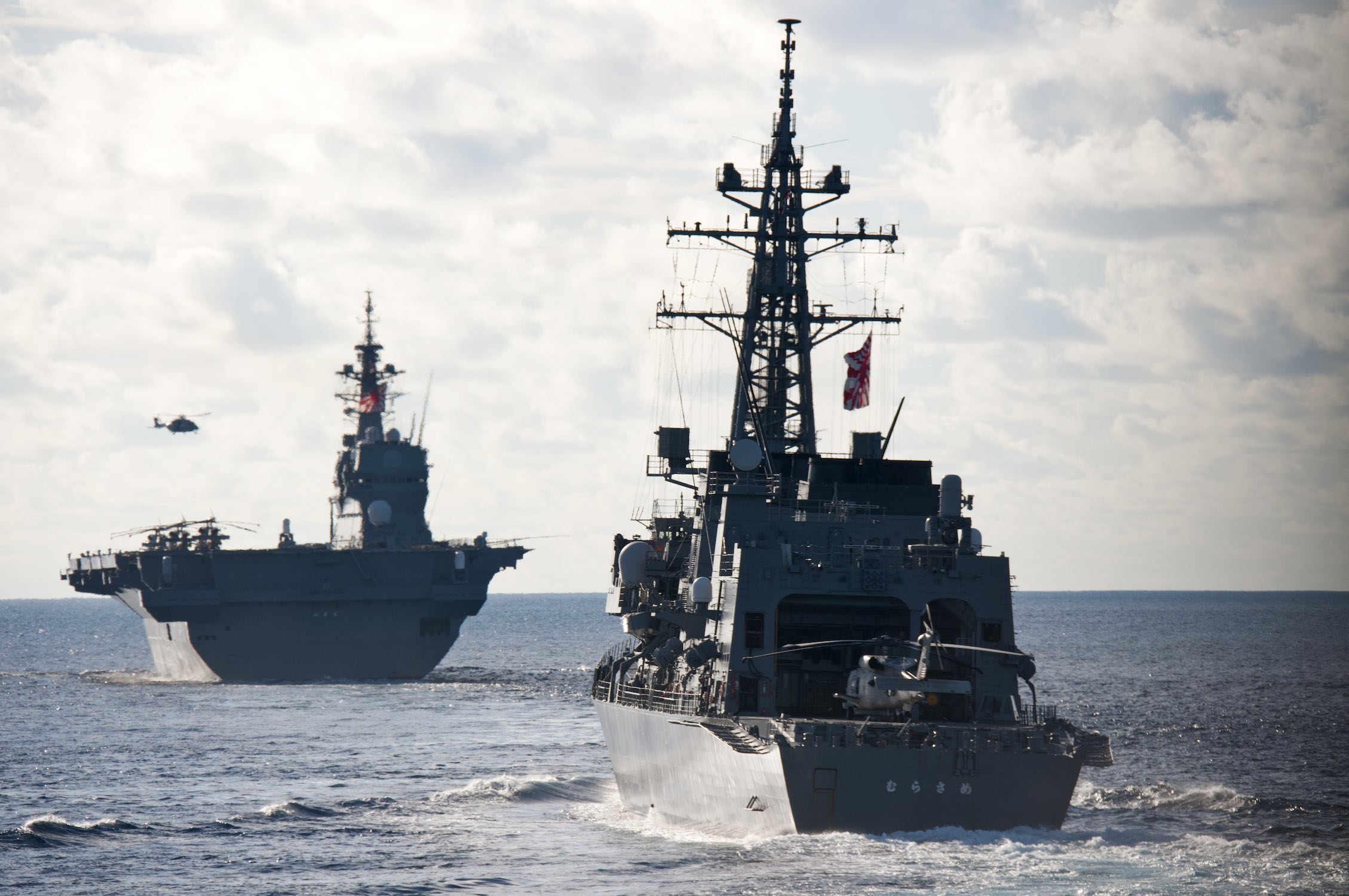 The Japan Maritime Self Defense Force Izumo-class helicopter destroyer JS Izumo and the Murasame-class destroyer JS Murasame