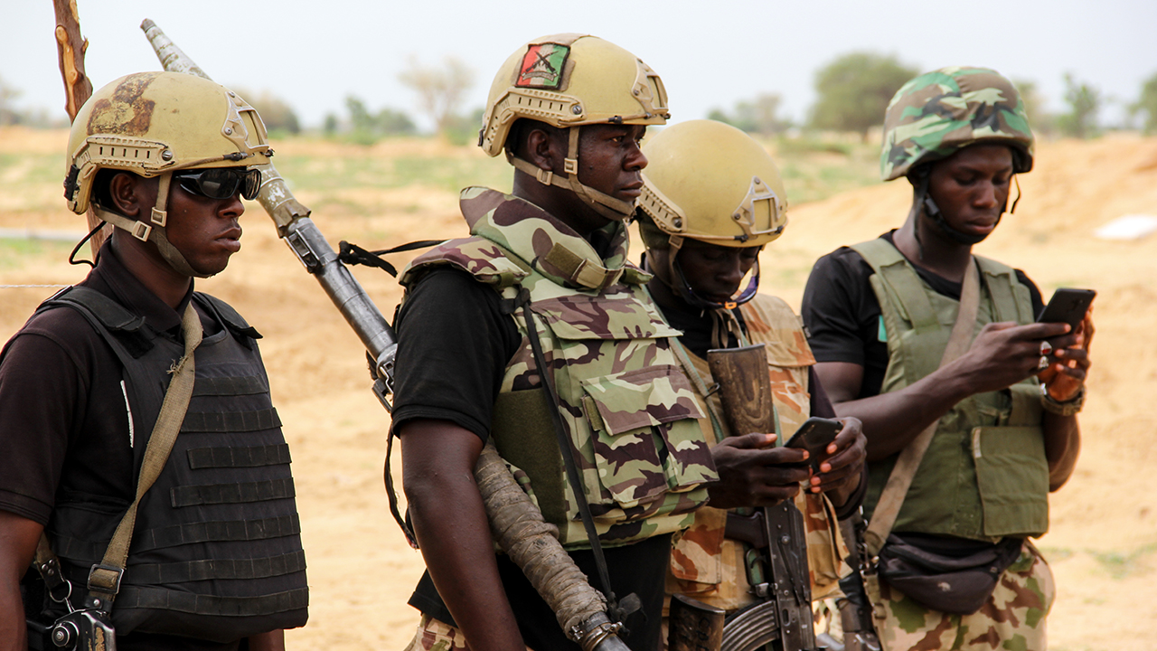 Nigerian army soldiers stand at a base