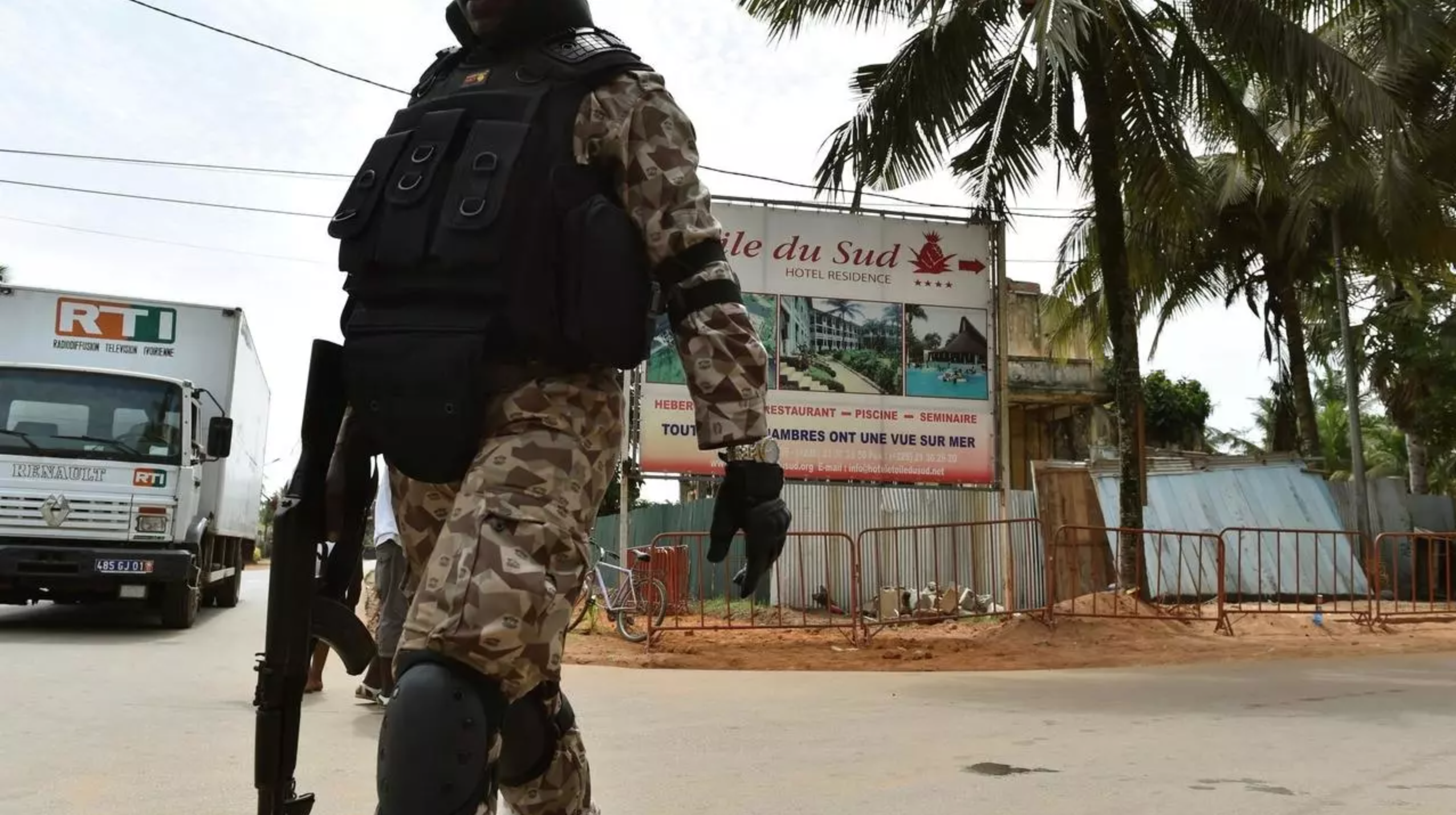 A soldier patrols near the hotel Etoile du Sud in Grand Bassam, Ivory Coast, on March 13, 2016 during a commemoration ceremony for the first anniversary of the 2016 Grand Bassam beach terrorist attack, resulting in the death of 19 people.