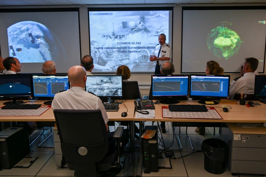 French minister of Defence Florence Parly (rear C) sits during a presentation of the new Defence space Strategy as she visits the Command of Air Defence and Air Operations (Commandement de la defense aerienne et des operations aeriennes - CDAOA) in the base 942 on the Verdun mount in Poleymieux-au-Mont-d'Or near Lyon, eastern France, on July 25, 2019