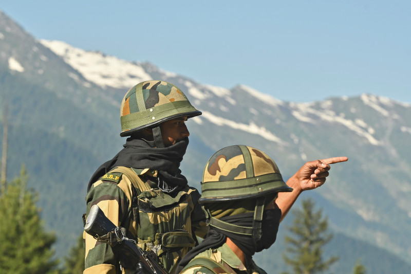 Indian Border Security Force (BSF) soldiers guard a highway leading towards Leh, bordering China, in Gagangir on June 17, 2020.