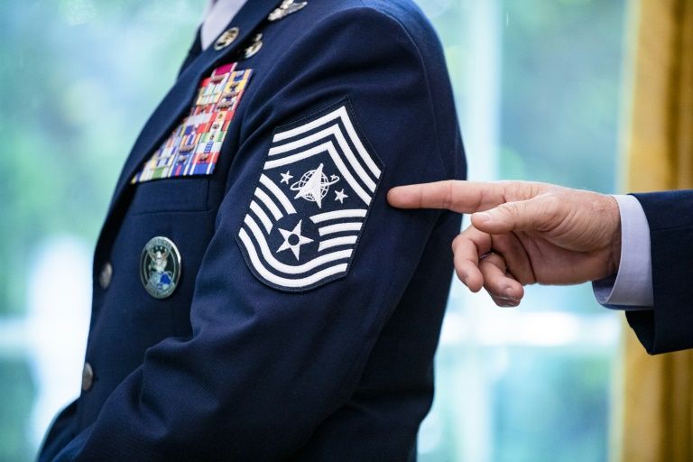 Chief Master Sgt. Roger Towberman displays his insignia during a presentation of the United States Space Force flag in the Oval Office of the White House, Friday, May 15, 2020.