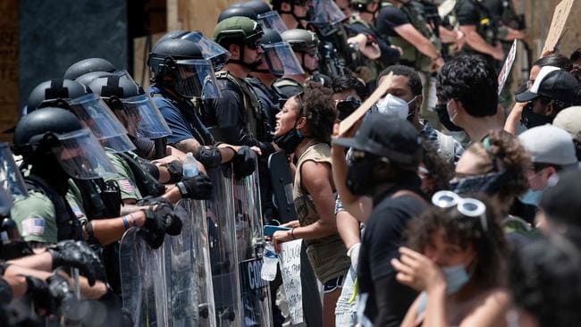 protestors facing police