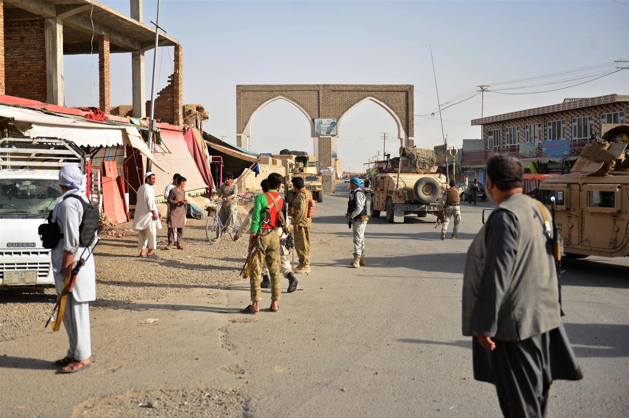 Afghan security forces stand along a road during clashes against Taliban militants Aug. 12, 2018