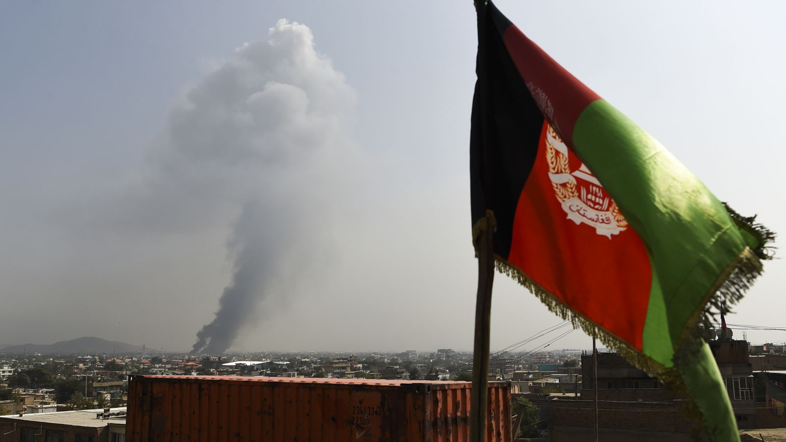 Smoke rises from the site of an attack after a massive explosion the night before near the Green Village in Kabul, September 2019