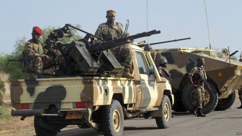 Armed Cameroon soldiers on a jeep