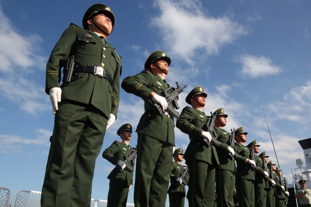 The Chinese coastguard stand in attention.