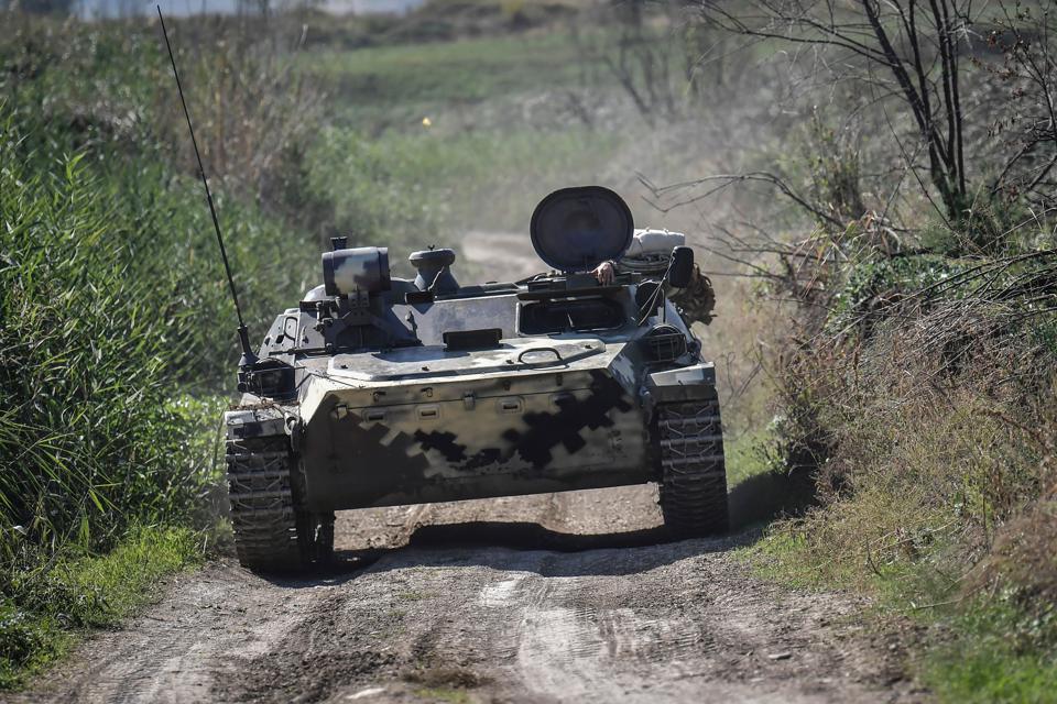 An Armenian armoured vehicle drives towards the front line on October 25, 2020, during the ongoing fighting between Armenian and Azerbaijani forces over the breakaway region of Nagorno Karabakh.