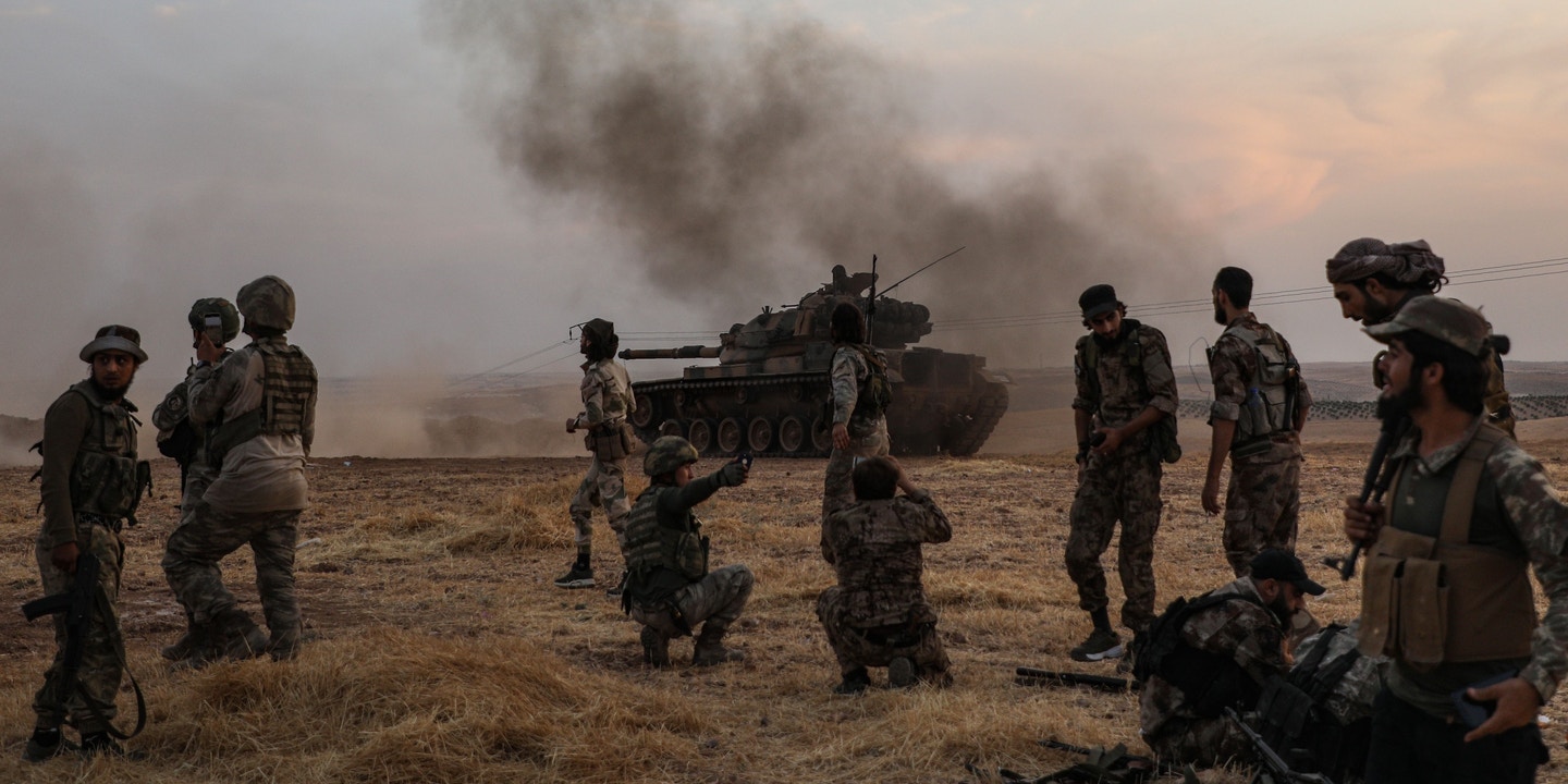 Turkish-backed Syrian fighters alongside Turkish soldiers in the Syrian city of Manbij.