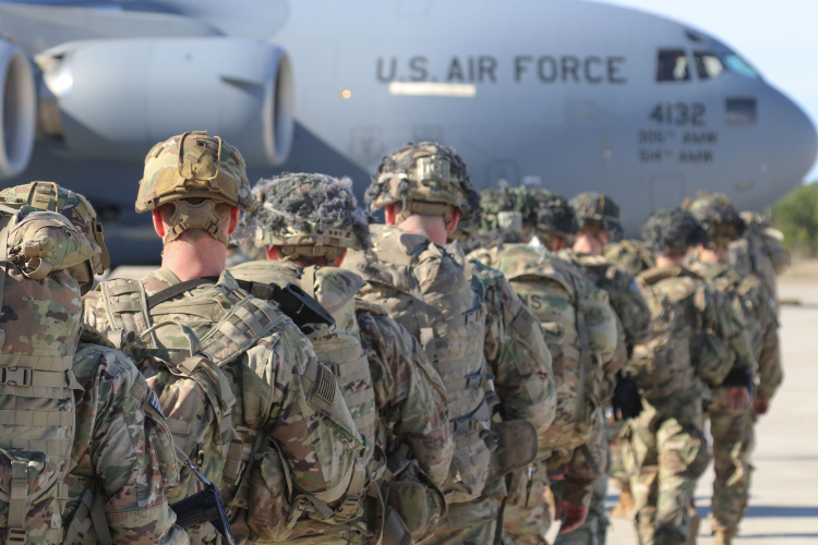 This handout picture released by the US Army shows U.S. Army Paratroopers assigned to the 2nd Battalion, 504th Parachute Infantry Regiment, 1st Brigade Combat Team, 82nd Airborne Division, deploy from Pope Army Airfield, North Carolina on January 1, 2020