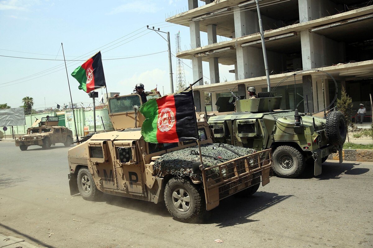 Afghan security personnel gather near a prison in Kabul.