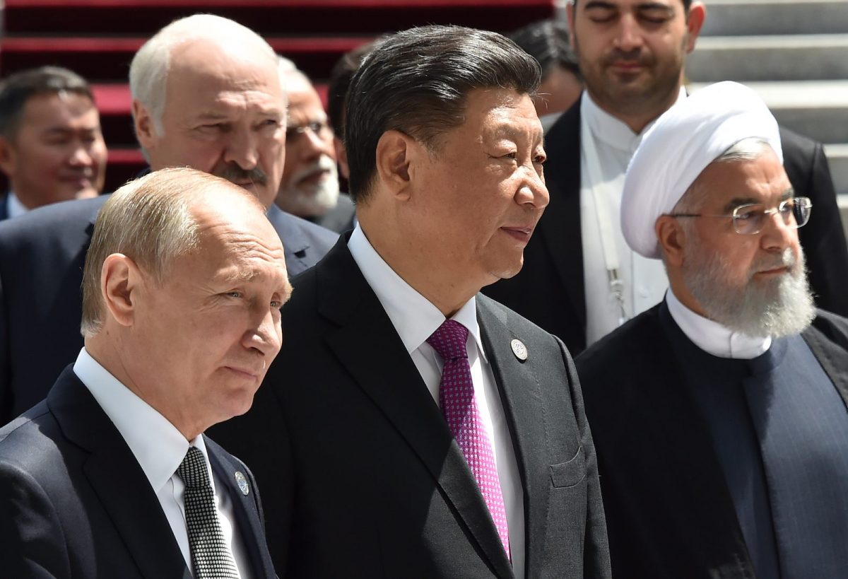 Russian President Vladimir Putin, Chinese President Xi Jinping and Iran's President Hassan Rouhani walk as they attend a meeting of the Shanghai Cooperation Organization (SCO) Council of Heads of State in Bishkek on June 14, 2019.