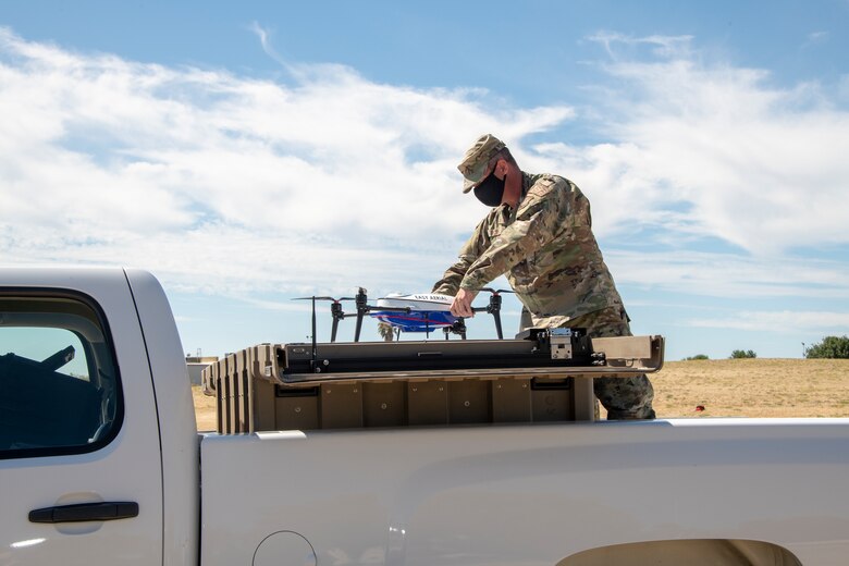 U.S. Air Force Master Sgt. Joshua Hicks, 60th Security Forces Squadron flight chief, secures an Easy Aerial drone inside of the ground charging station July 10, 2020, at Travis Air Force Base, California.