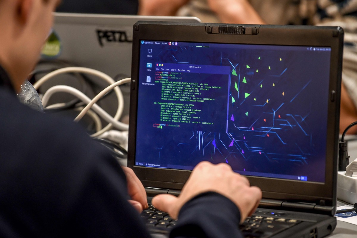 A man works on a laptop during the 11th International Cybersecurity Forum.
