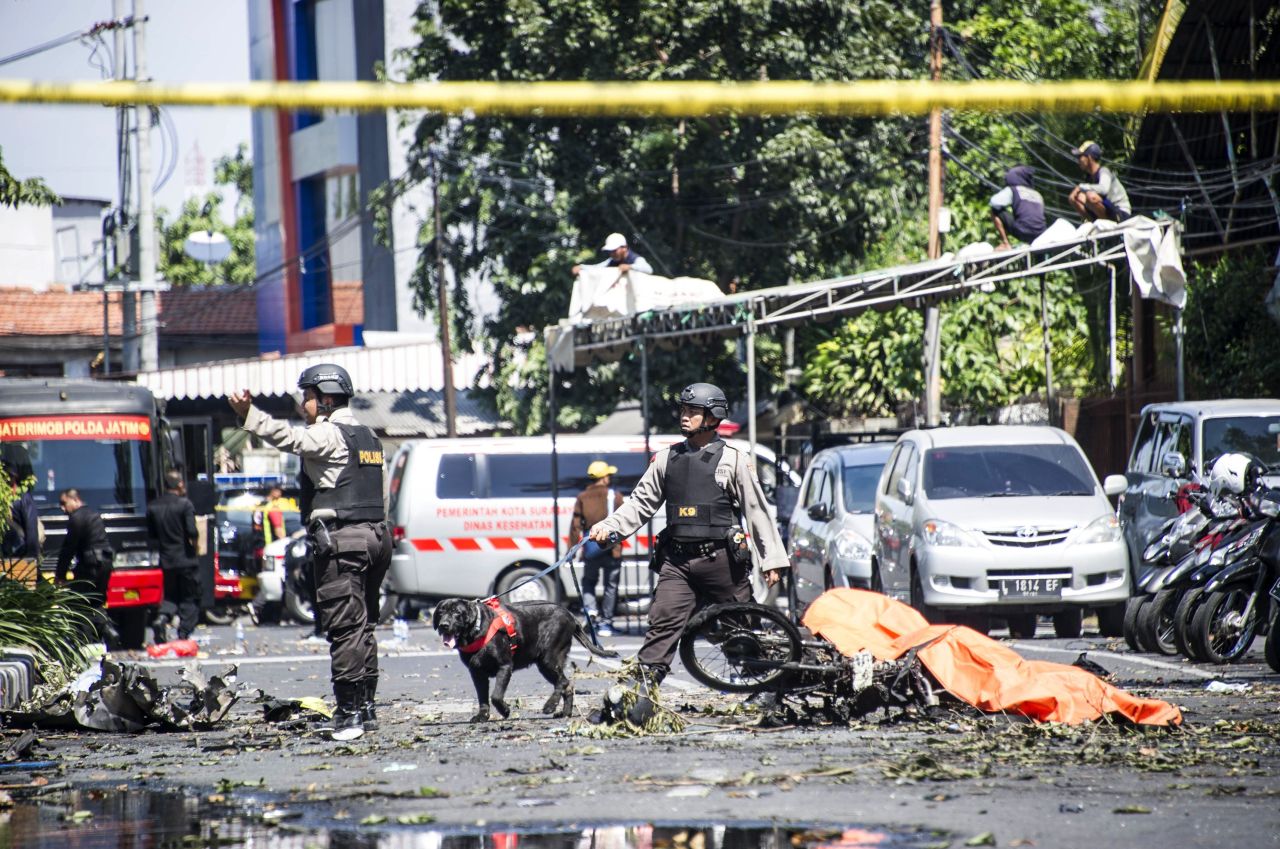 K9 police examine a site following attacks outside the Surabaya Centre Pentecostal Church. 