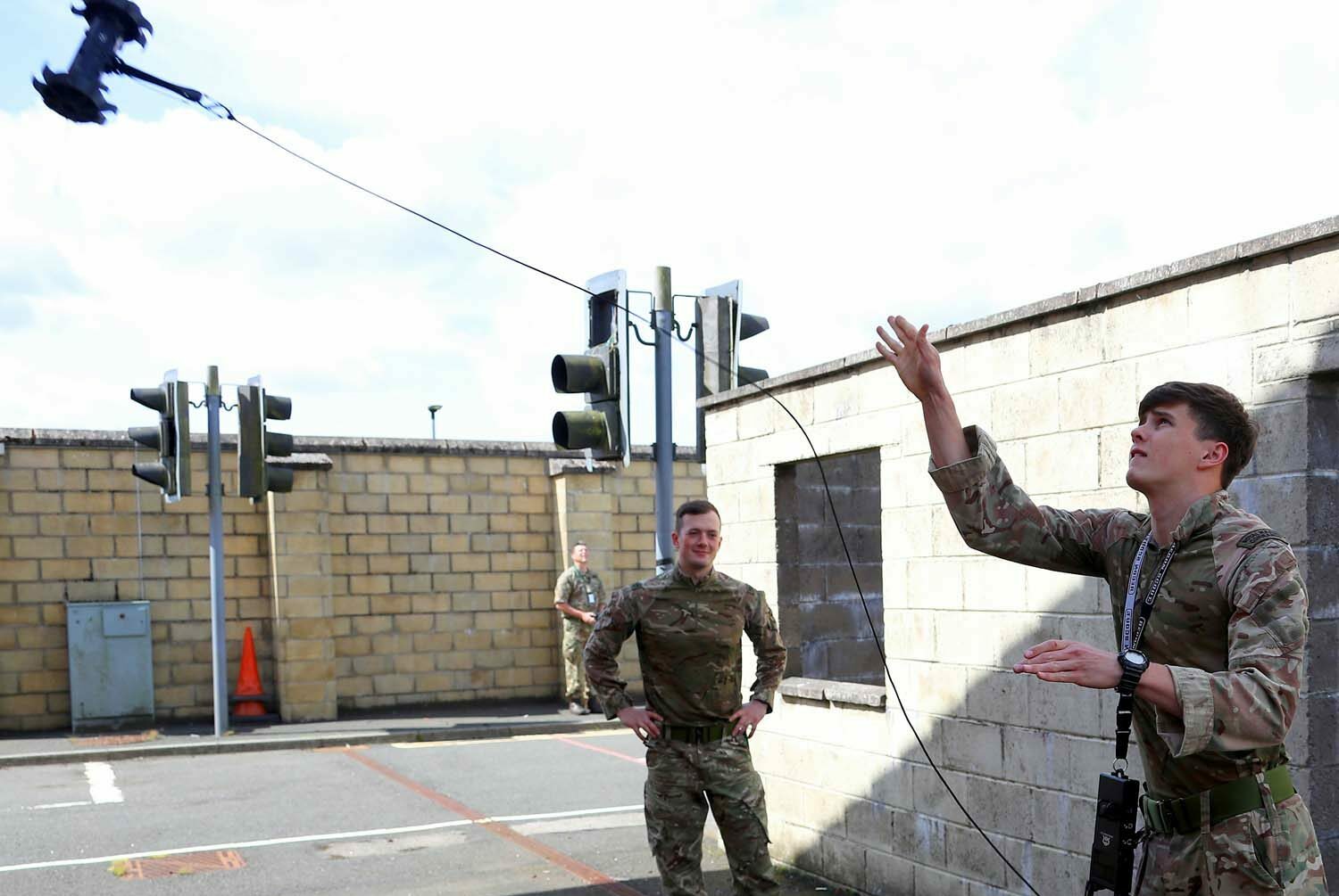 A Royal Marine commando lobs a 