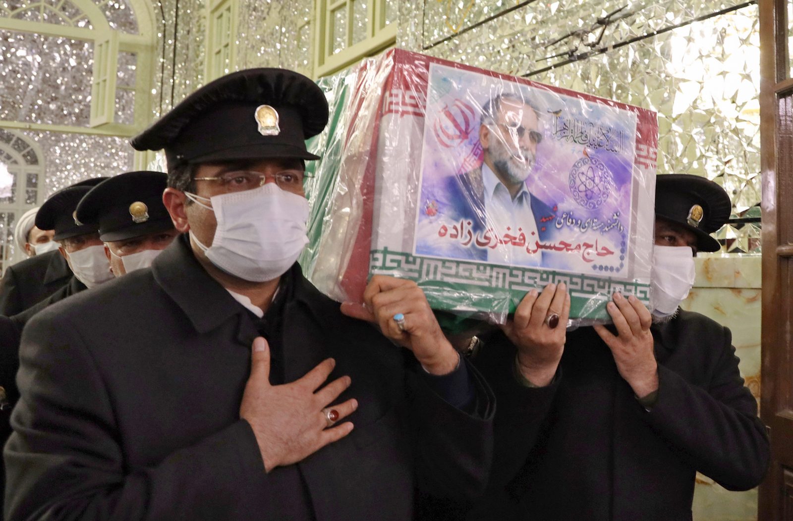 Servants carry the coffin of Iran's assassinated top nuclear scientist Mohsen Fakhrizadeh