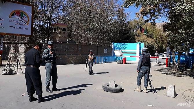 Policemen stand guard at an entrance gate of Kabul University in Kabul, Afghanistan, on November 2, 2020.