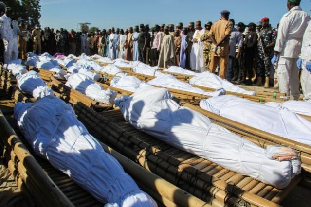 Mourners attend the funeral of 43 farm workers in Zabarmari, Nigeria on Nov 29, 2020 after they were killed by jihadists in rice fields near the village of Koshobe on November 28, 2020