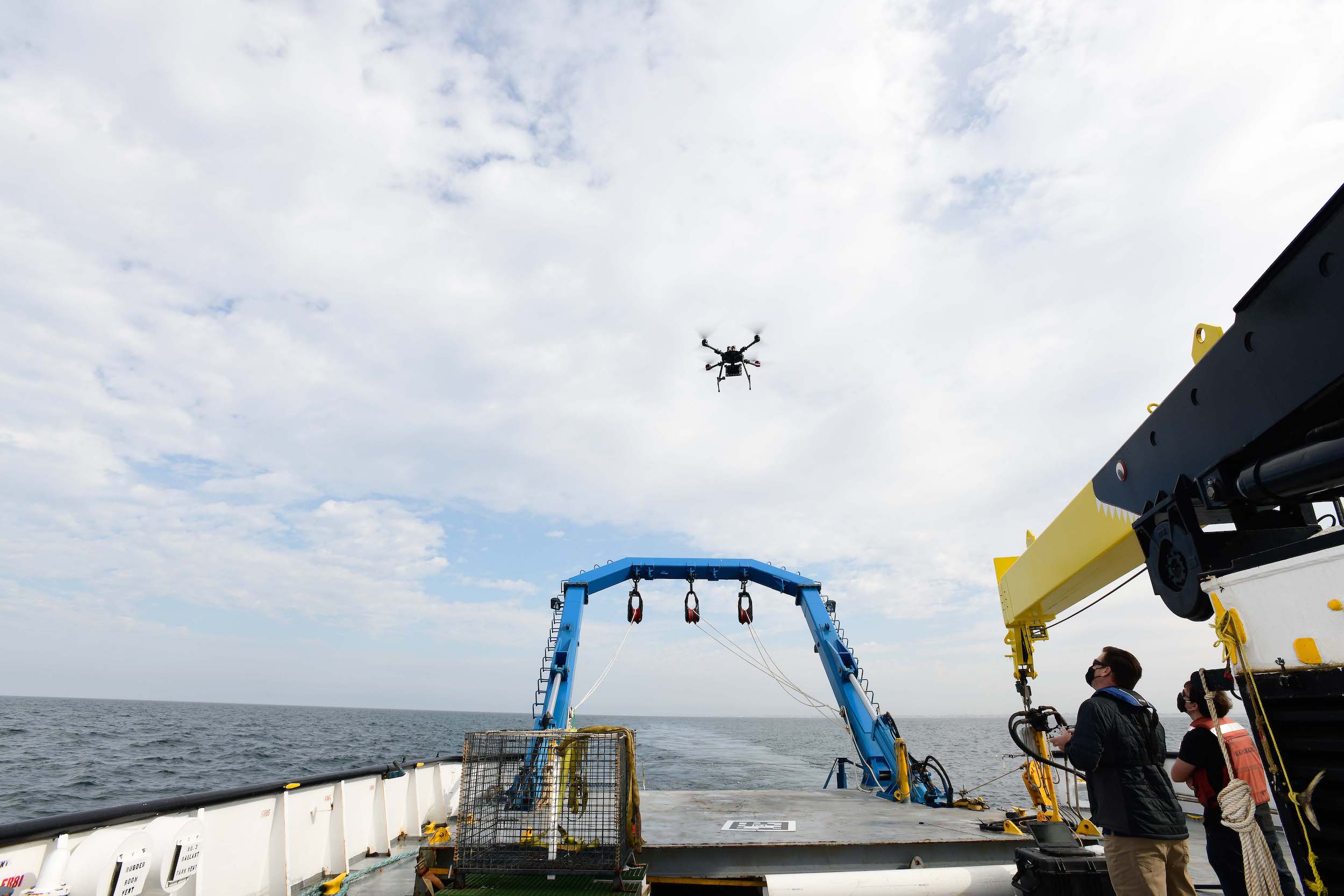 NSWC PHD Research Technology Applications Manager Alan Jaeger and Cybersecurity Researcher Ian Wilson test out the capabilities of a quadcopter drone at the stern of a ship on Friday, September 18.
