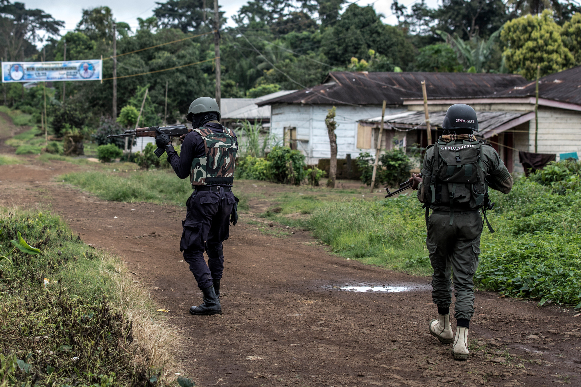 A Cameroonian policeman and a gendarme securing the perimeter of a polling station in Lysoka, near Buea, southwestern Cameroon, on October 7, 2018.