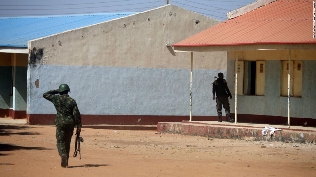Nigerian soldiers walk inside the school on December 15, where gunmen abducted students in Kankara, Nigeria.