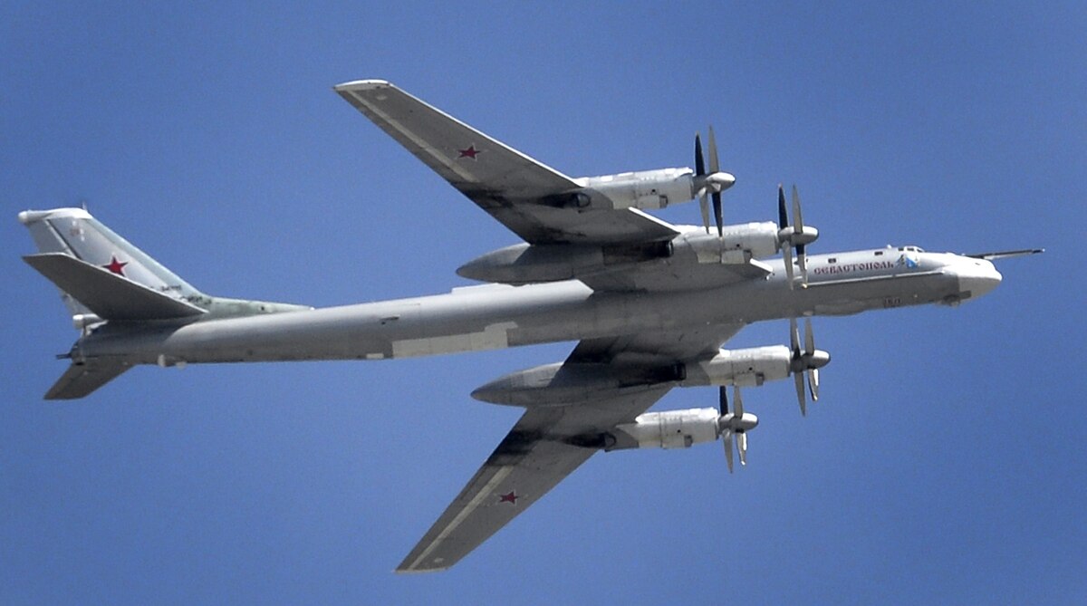 A Russian Tupolev Tu-95 turboprop-powered strategic bomber flies above the Kremlin in Moscow, on May 7, 2015, during a rehearsal for the Victory Day military parade.