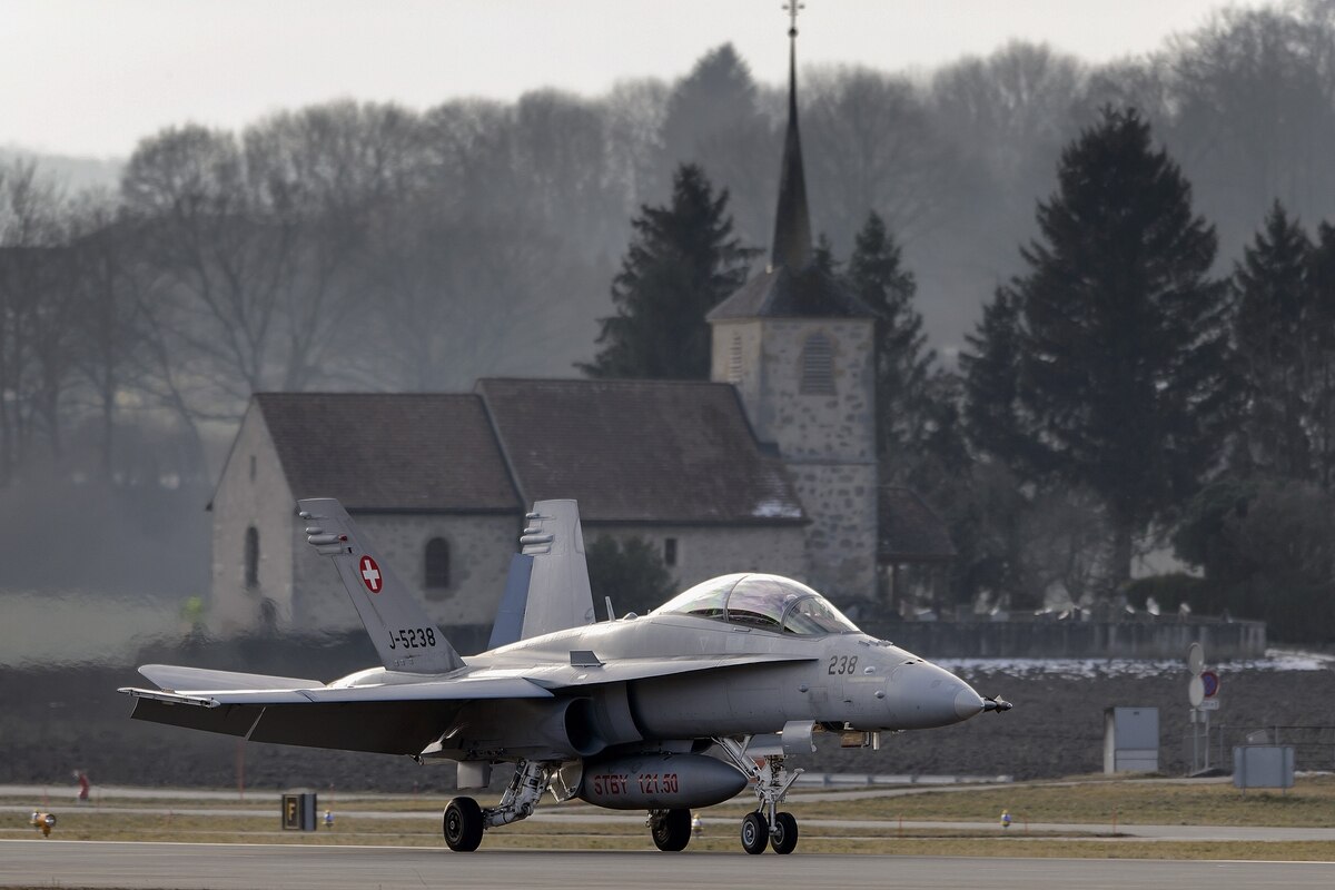 A Swiss Air Force F-18 is seen in front of a church on Feb. 20, 2013, at Payerne airport.