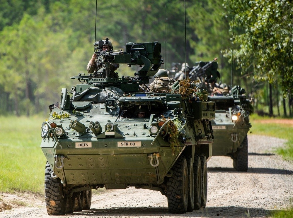 A column of eight-wheeled Stryker combat vehicles moves along a road at Fort Benning, Georgia, September 2, 2020 during training