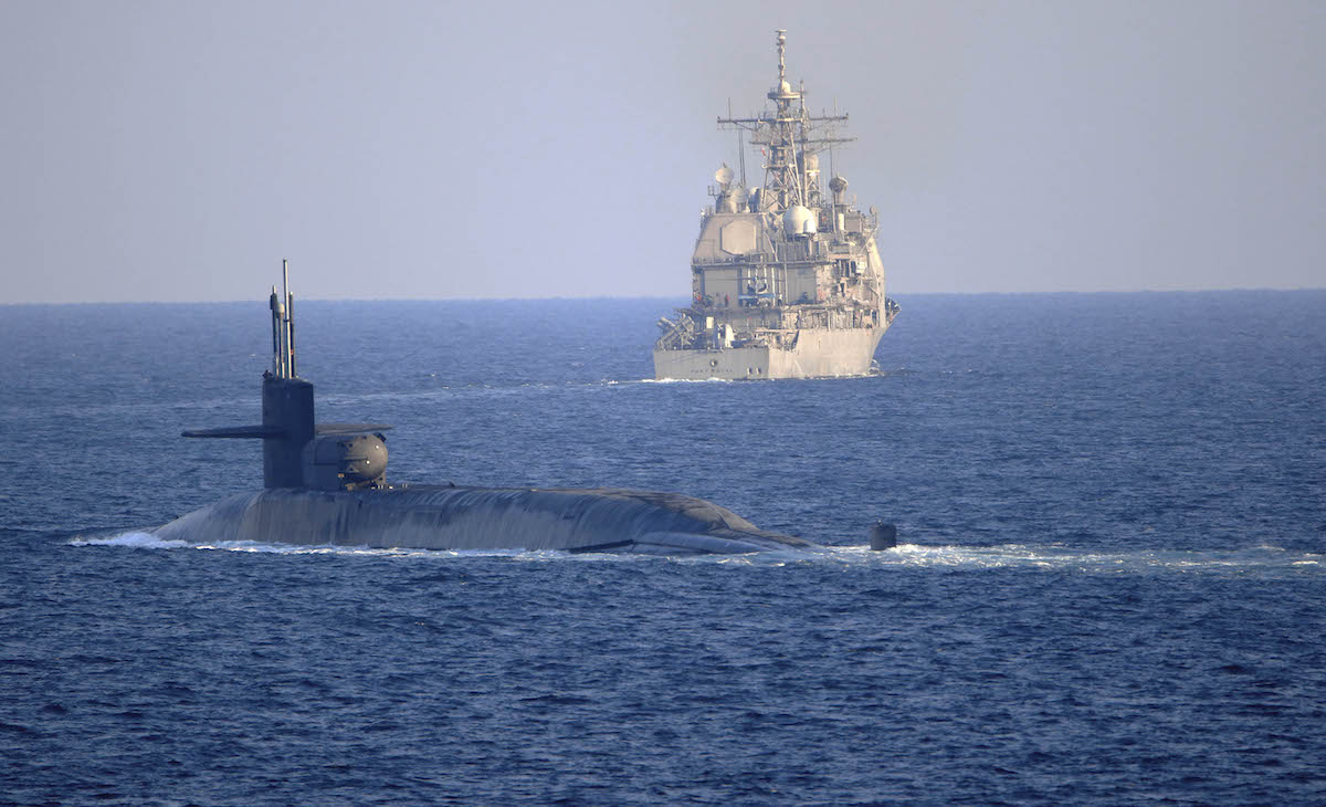 The Ohio-class guided-missile submarine USS Georgia (SSGN 729) transits with the Ticonderoga-class guided-missile cruiser USS Port Royal (CG 73) and the Ticonderoga-class guided-missile cruiser USS Philippine Sea (CG 58), not shown, in the Strait of Hormuz, December 21, 2020