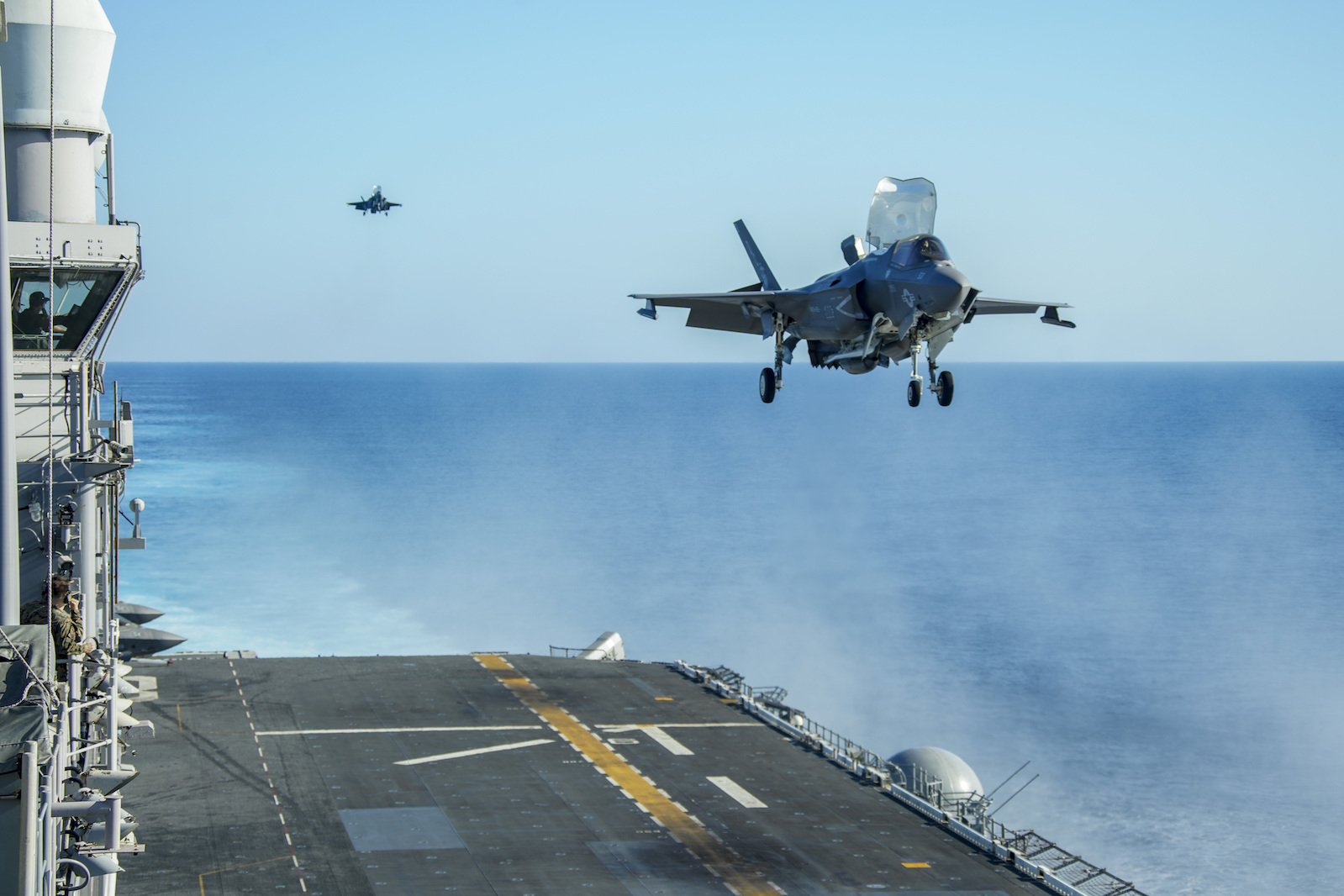 US Marine Corps F35-B prepares to land on the flight deck of the amphibious assault ship USS Makin Island.