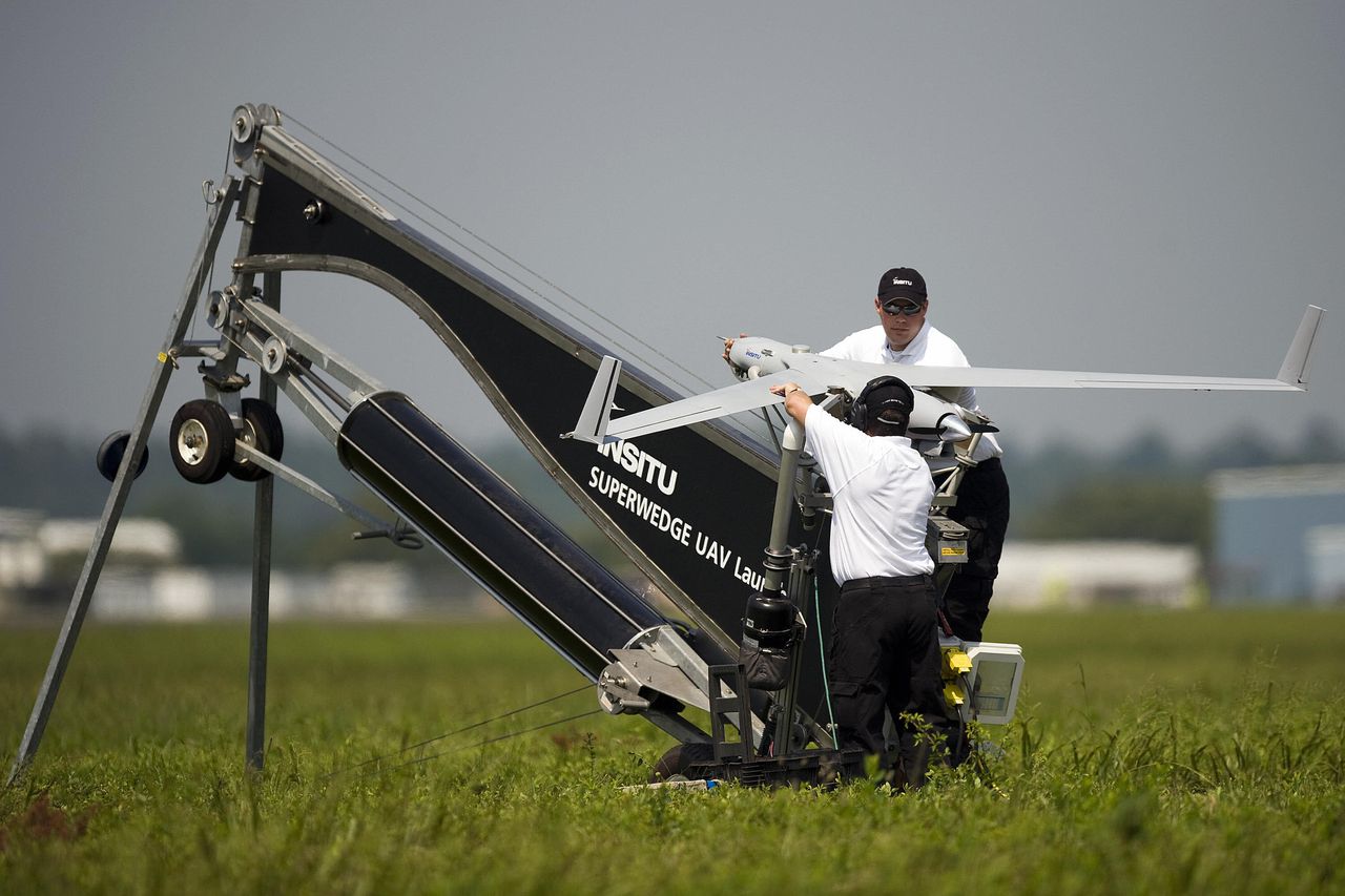 two men with Insitu ScanEagle drone