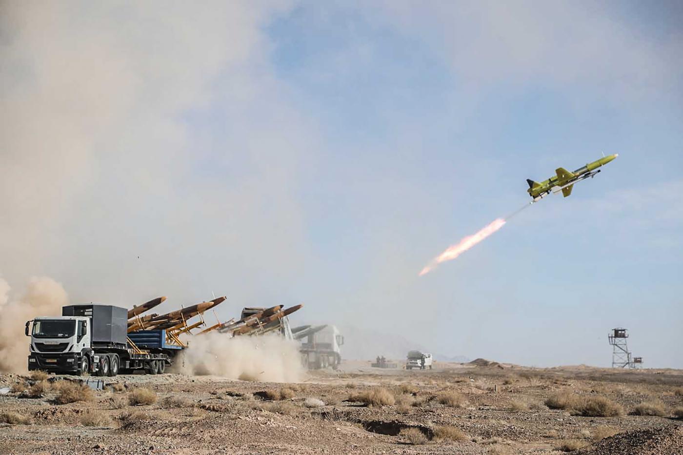 A handout photo from the Iranian Army on 6 January 2021 shows the launching of a drone carrying a missile, during a military drill in central Iran