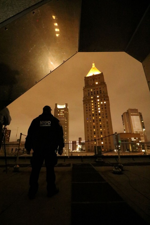 Detective Ralph Gonzalez, Counter Unmanned Aerial Systems Team Lead, New York City Police Department Counterterrorism Division, observes CUAS detection testing from a rooftop as Dense Urban CUAS Materiel Experiment 21-1 was underway in lower Manhattan on October 24