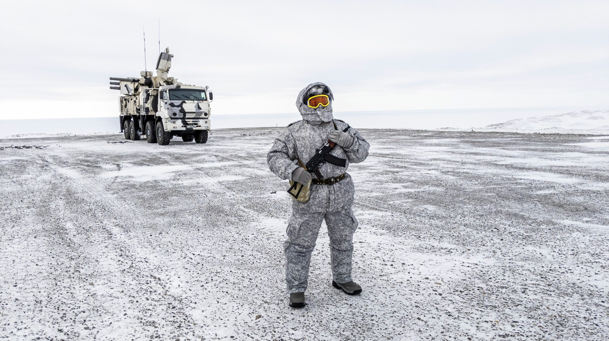 A soldier holds a machine gun as he patrols the Russian northern military base on Kotelny island, beyond the Artic circle on April 3, 2019.