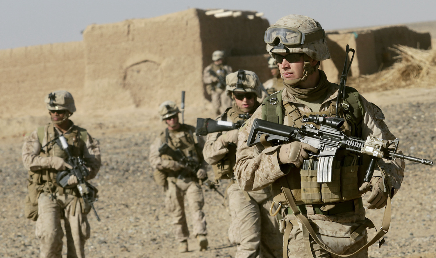 US Marine Sgt. Bryan Early, a squad leader with 1st Battalion, 9th Marine Regiment, leads his squad of Marines to the next compound while patrolling in Helmand province, Afghanistan